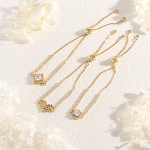 Close-up of adjustable 18K gold plated bracelets with sparkling zircon charms and petals