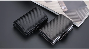 Macro detail of carbon fiber texture and automatic pop-up button on RFID card holder