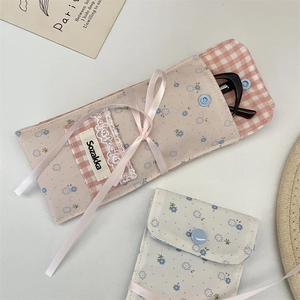 Detail of floral patchwork eyeglass pouch with lace trim and soft pink ribbon accent