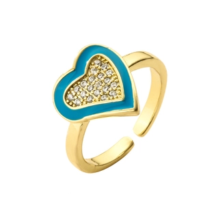 Detail of gold-plated heart ring featuring blue enamel and micro-set white cubic zirconia