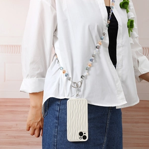 Detail of beaded crystal phone lanyard worn over shoulder with a white textured case