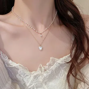 Double-layered French pearl necklace with heart pendant and zircon in golden finish