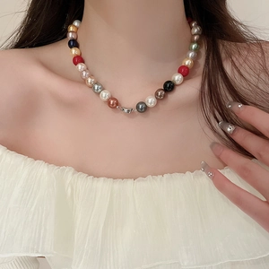 Detail of colorful faux pearl necklace with multi-color beads on a fashion model neckline