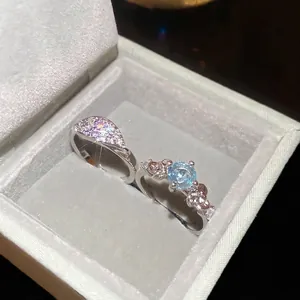 Elegant floral open ring set with sparkling zircons and a round sky blue stone