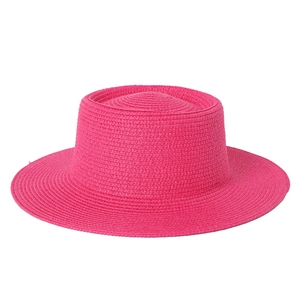 Detail of rose red straw boater hat with fine spiral woven texture and flat top