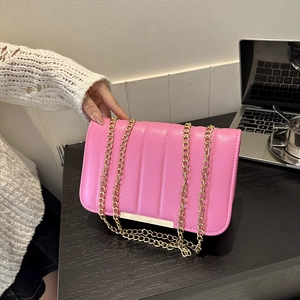 Pink quilted shoulder bag with gold chain strap and vertical stripe pattern design