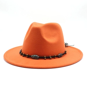 Detail of orange wool fedora featuring a black braided band with vintage bronze beads