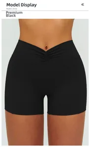 Detail of high-waist black yoga shorts featuring V-shaped crossover and ruched design