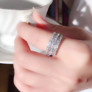 Close-up of a silver multi-row sparkling zircon ring worn on a finger for party style