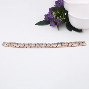 Detailed view of a rose gold magnetic titanium steel bracelet for men on a white background