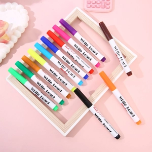 Flat lay of colorful magic floating pens on a white frame with pink background decor