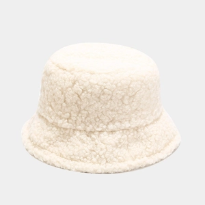 Detailed close-up showing the soft lamb wool texture of the cream winter bucket hat