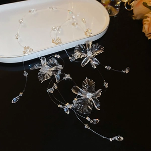 Detailed close-up of transparent crystal flower necklace with elegant tassel drop details
