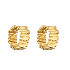Detail shot of chunky gold hoop earrings featuring irregular wavy textured metal surface