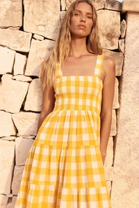Detail of yellow gingham dress showing smocked chest and square neck strap design