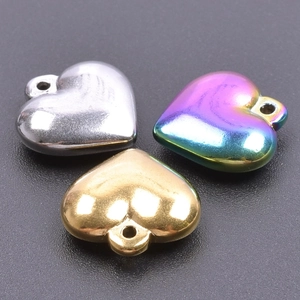 Three 3D stainless steel heart pendants in silver, gold, and rainbow iridescent colors