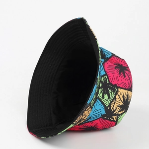 Detail of colorful reversible bucket hat with tropical palm tree print and black lining