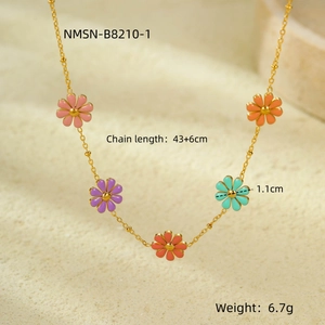 Macro detail of 18K gold-plated chain with colorful pink and purple enamel daisy pendants