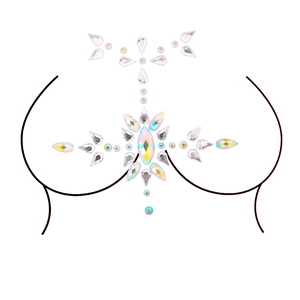 Detail of shimmering acrylic rhinestone breast stickers and body jewelry on white background