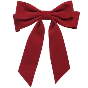 Close-up of a dark red velvet bow hair clip with matte texture and swallowtail cut edges