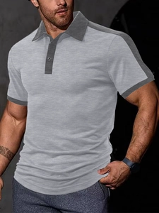 Detail view of men's polo shirt featuring grey color block design and polo collar
