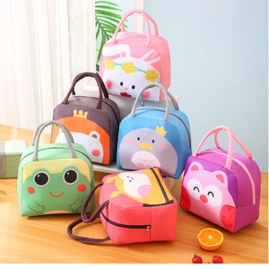 Collection of colorful cartoon thermal lunch bags with animal patterns on a wooden table