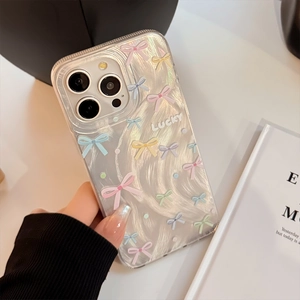 Detail of clear iPhone case with colorful bows and Lucky text over wavy IMD texture
