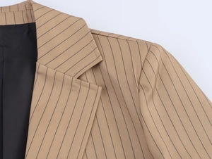 Detailed view of striped linen blazer lapel with sharp tailoring and fine fabric texture