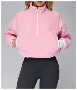 Close-up of pink fleece pullover with white half-zipper and soft sherpa texture detail