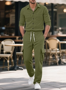 Detailed texture of olive green corduroy fabric on a men's workwear shirt and trousers