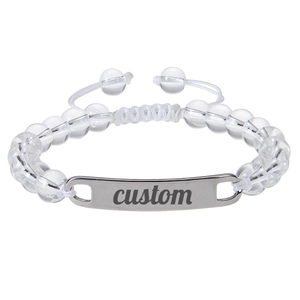 Detailed macro of a custom engraved metal bar on a beaded adjustable stone bracelet