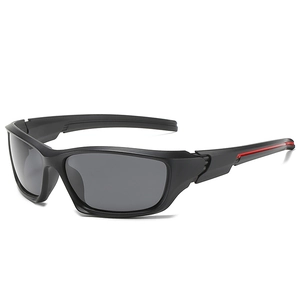 Close-up of black sports sunglasses featuring red accent stripes on the temples