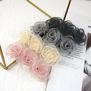 Detailed close-up of handmade tulle rose hair scrunchies in assorted soft pastel colors