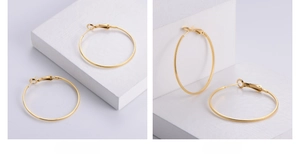 Detailed macro view of 18k gold plated hoop earrings with vacuum plating texture