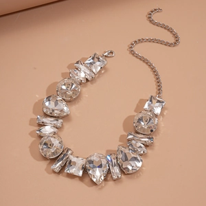 Detailed view of silver necklace with teardrop and square cut sparkling crystals