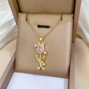 Macro shot of tulip pendant with pink teardrop gem and diamonds in a velvet box