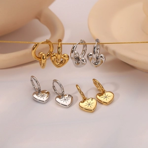 14k gold and silver heart earrings with minimalist pendants and sunburst engraving