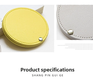 Detail of round PU leather makeup mirror showing litchi grain texture and metal rivet