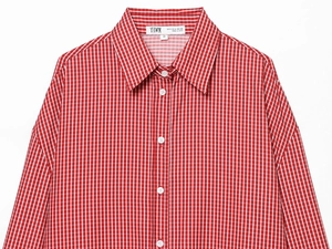 Close-up of red and white checkered poplin shirt collar with beaded detail and brand label