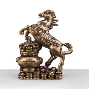 Traditional brass wealth horse statue on gold ingots and treasure basin for success