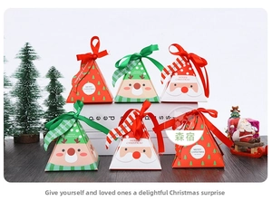 Detail of Christmas triangle paper gift boxes with Santa patterns and satin ribbons