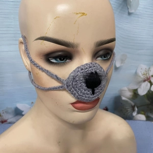 Close-up of grey crochet animal nose warmer with hand-knitted texture and ear loops