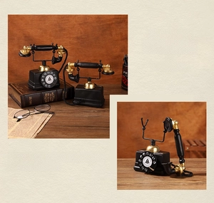 Close-up of vintage industrial telephone model with matte black finish and gold accents