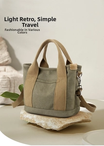 Detail of vintage olive canvas bag featuring a khaki strap on a natural stone surface