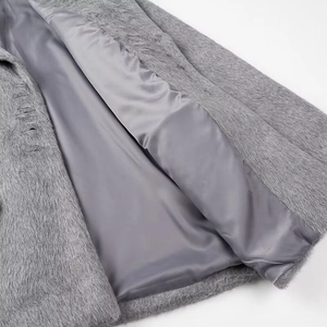 Detail of plush grey wool fabric texture and smooth satin lining on long coat