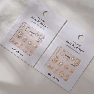 Macro shot of 3D nail art accessories with gold and silver metallic flower pearl designs