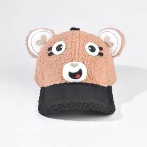 Close-up of fluffy teddy bear ears with embroidered heart and cute cartoon puppy face