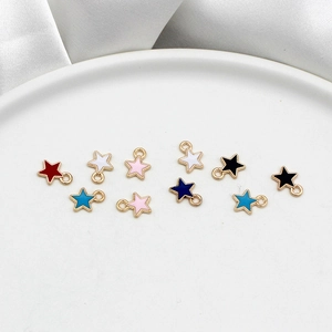 Macro shot of colorful star alloy pendants with gold borders and enamel drip finish