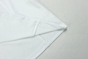 Detailed macro view of white dress hem with professional double-needle stitching quality