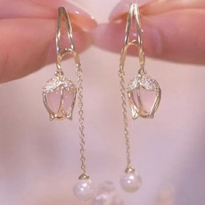 Detail of tulip earrings with pink flower petals and long hanging pearl tassel chains